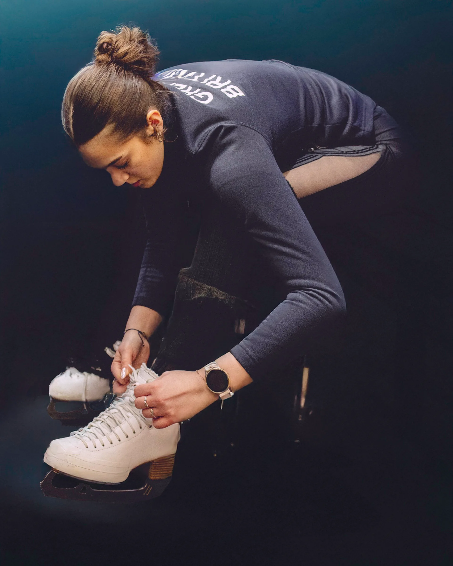 Lily Bakhtiari preparing her skates before training